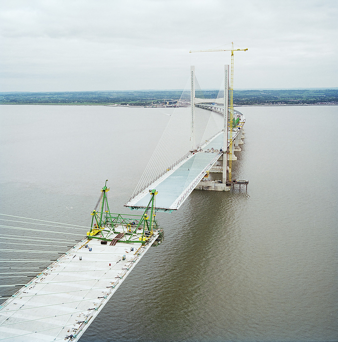 Second Severn Crossing, M4, New Passage, Pilning and Severn Beach, Gloucestershire, 18 10 1995. Creator: John Laing plc. A view looking east from near the top of the Second Severn Crossing during its construction, showing cables supporting the deck of the bridge and work being carried out to join the deck units. The Second Severn Crossing took four years to build and was a joint civil engineering project between Laing Civil Engineering and the French company GTM. The work started in April 1992 and the opening ceremony later took place on 5th June 1996. The crossing is a cable stayed bridge which stretches over 5000 metres across the River Severn connecting England and Wales, 3 miles downstream from the Severn Bridge which opened in 1966.