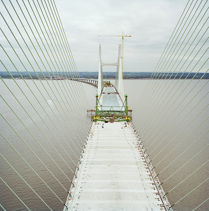 Second Severn Crossing, M4, New Passage, Pilning and Severn Beach, Gloucestershire, 18 10 1995. Creator: John Laing plc. A view looking east along the deck of the bridge during the construction of the Second Severn Crossing, showing cables supporting the deck of the bridge and work being carried out to join the deck units. The Second Severn Crossing took four years to build and was a joint civil engineering project between Laing Civil Engineering and the French company GTM. The work started in April 1992 and the opening ceremony later took place on 5th June 1996. The crossing is a cable stayed bridge which stretches over 5000 metres across the River Severn connecting England and Wales, 3 miles downstream from the Severn Bridge which opened in 1966.