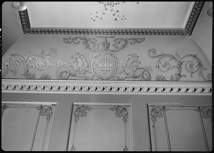 Trinity House, Trinity House Lane, City of Kingston Upon Hull, 1941. Creator: George Bernard Wood. Trinity House, Trinity House Lane, City of Kingston Upon Hull, 1941. A detailed view of plaster wall panels and coving in the Court Room in Trinity House. The walls of the room have raised plaster panels and elaborate coving with plaster swags and paintings of mythical beasts: in the image are two hippocampi, or sea horses, either side of an emblem with an anchor. The court room is part of Trinity House, consisting of offices and houses in a polygonal plan around two interior courtyards. The main block dates to 1753 and the Guild House is c1775, with the remaining buildings constructed in the 18th and 19th centuries.