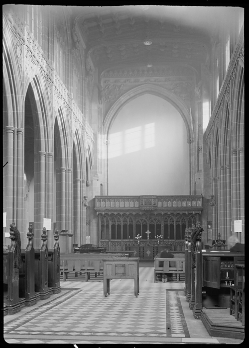 Cathedral Church of St Mary, Fennel Street, Manchester, 1942. Creator: George Bernard Wood. Cathedral Church of St Mary, Fennel Street, Manchester, 1942. An interior view of Manchester Cathedral, or St Mary s Cathedral Church, showing the east end of the nave. Originally a collegiate parish church built between c1422 and 1520, the church received cathedral status in 1847. It underwent restoration or rebuilding between 1814 1815, 1862 1868, 1885 1886 and 1898. The cathedral has a west tower with a west porch and choir rooms, an aisled nave with north and south chapels and porches. The choir and presbytery are aisled, and have chapels north of the north aisle, and a vestry, library, chapter house and chapel south of the south aisle. To the east is a rectrochoir and lady chapel. The aisled nave has six bays and at the eastern end is a rood screen, erected by Bishop Stanley and re worked by Sir George Gilbert Scott in 1872. It has a central entrance flanked by three two light openings on each side. The parapet above was added by Scott, and has a projecting octagonal section. In the image, a screen or fabric hangs over the rood screen. The cathedral church was damaged during bombing in the Second World War.