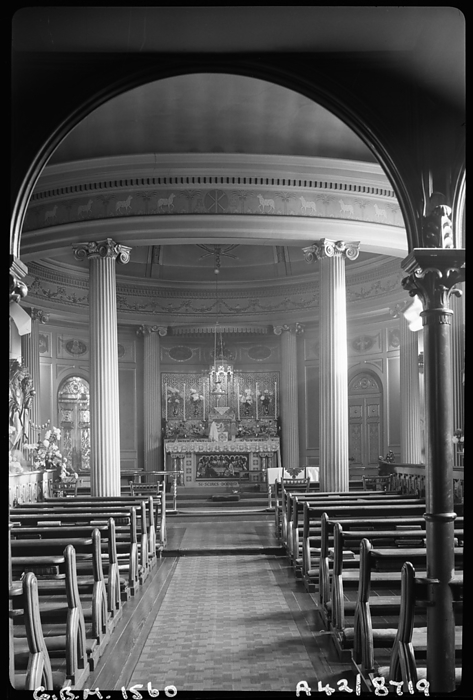 Bar Convent, Blossom Street, York, 1942. Creator: George Bernard Wood. Bar Convent, Blossom Street, York, 1942. An interior view of the Bar Convent Chapel, looking towards the domed sanctuary from underneath a round headed gallery arch. The chapel is part of the convent and school of the Institute of the Blessed Virgin Mary. The chapel block dates to 1766 1769 and is situated south east of the convent. The chancel is domed and has an Ionic rotunda of eight columns. The nave has three bays, with a north and south transept at the eastern end. To the west is an organ gallery supported by an arcade of three round headed arches. It has a wrought iron balustrade, and underneath are panelled double doors.