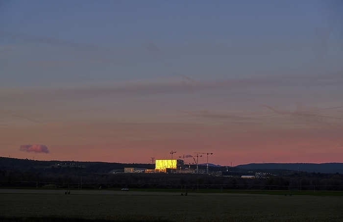 ITER fusion research reactor building at sunrise ITER  International Thermonuclear Experimental Reactor  fusion research reactor building, Cadarache, France, at sunrise. Thirty five nations are collaborating to build the world s largest tokamak, a magnetic fusion device that has been designed to prove the feasibility of fusion as a large scale and carbon free source of energy based on the same principle that powers our Sun and stars. Photographed in 2015., Creditline:CHRISTIAN LUNIG   SCIENCE PHOTO LIBRARY
