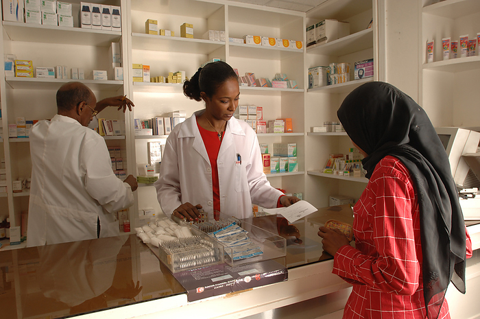 Pharmacist collecting prescription drugs Pharmacist collecting prescription drugs for a customer., Creditline:MEDICIMAGE   SCIENCE PHOTO LIBRARY