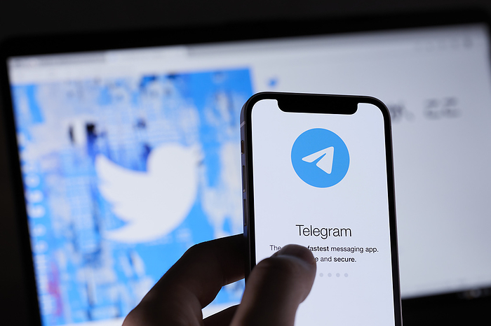 smartphone app The logo of Telegram is seen on a smartphone and Twitter s website is displayed on a screen in Tokyo, Japan, October 18, 2021.  Photo by Shingo Tosha AFLO 