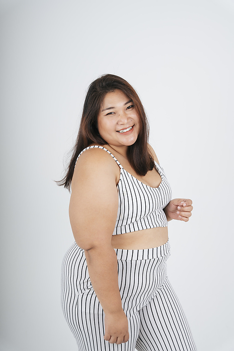 Portrait of healthy asian chubby woman on white background.