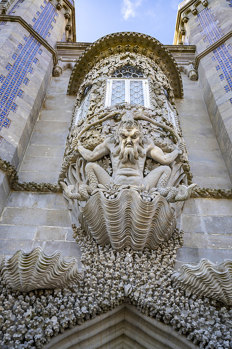 Lisbon, Portugal Close up of the stonework of Triton Arch with a mythical, merman gargoyle guarding the entrance at the hilltop castle of Palacio Da Pena situated in the Sintra Mountains  Sintra, Lisbon District, Portugal, Photo by Chris Caldicott   Design Pics