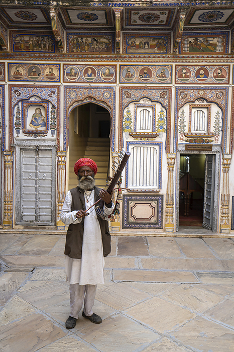 India Musician performing in the courtyard of a painted haveli in Nawalgarh, Rajasthan, India  Nawalgarh, Shekawati, Rajasthan, India, Photo by Chris Caldicott   Design Pics
