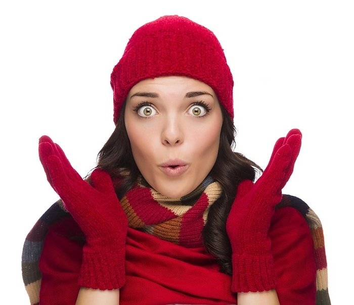 Expressive mixed-race woman wearing winter hat and gloves isolated on white background, Photo by Andy Dean