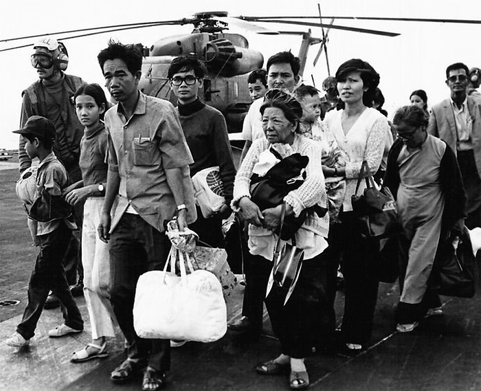 Vietnam: Refugees from the defeated Republic of Vietnam being evacuated to the flight deck of a US carrier in the South China Sea, April 1975 Operation Frequent Wind was the evacuation by helicopter of American civilians and  at risk  Vietnamese from Saigon, South Vietnam, on 29 30 April 1975 during the last days of the Vietnam War.  More than 7,000 people were evacuated from various points in Saigon, and the airlift left a number of enduring images. More than 7,000 people were evacuated from various points in Saigon, and the airlift left a number of enduring images. br   br   br  The airlift was a large, but not large, part of the Vietnam War.  More than 7,000 people were evacuated from various points in Saigon, and the airlift left a number of enduring images. br   br   Preparations for the airlift already existed as a standard procedure for American embassies. By mid April, contingency plans were in place and preparations were underway for a possible helicopter evacuation. As the imminent collapse of Saigon became evident, Task Force 76 was assembled off the coast near Vung Tau to support a helicopter evacuation and provide air support if required. Air support was not needed as the North Vietnamese recognized that interfering with the evacuation could  br   br   br  Air support was not needed as the North Vietnamese recognized that interfering with the evacuation could provoke a forceful reaction from US forces.  On April 28, Tan Son Nhut Air Base came under artillery fire and attack from Vietnamese People s Air Force aircraft. The fixed wing evacuation was terminated and Operation Frequent Wind commenced. br   br   br  The fixed wing evacuation was terminated and Operation Frequent Wind commenced.  The evacuation was to take place primarily from DAO Compound and began around two in the afternoon on 29 April and was completed that night with only limited The US Embassy, Saigon was intended to only be a secondary evacuation point for Embassy staff, but was soon The evacuation of the Embassy was completed at 07:53 on 30 April, but some 400 third country nationals were left behind.