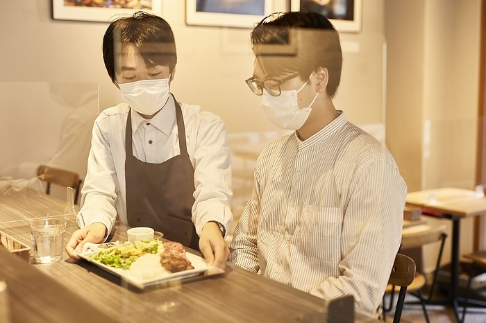 Japanese male waiter serving food