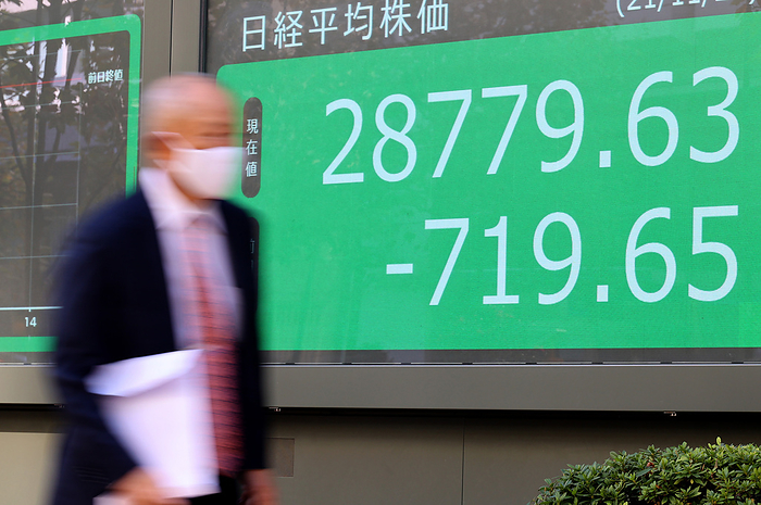 Japan s share prices fell 719.65 yen at the Tokyo Stock Exchange November 26, 2021, Tokyo, Japan   A pedestrian passes before a share prices board in Tokyo on Friday, November 26, 2021. Japan s share prices fell 719.65 yen to close at 28,779.63 yen at the morning session of the Tokyo Stock Exchange on a fear of the new COVID 19 variant found in South Africa.     Photo by Yoshio Tsunoda AFLO 
