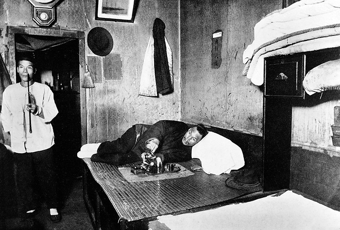 USA: Two Chinese men in a San Francisco opium den, 1890s. San Francisco s Chinatown was the port of entry for early Hoisanese and Zhongshanese Chinese immigrants from the Guangdong province of southern China from the 1850s to the 1900s. The area was the one geographical region deeded by the city government and private property owners which allowed Chinese persons to inherit and inhabit dwellings within the city. br   br    The majority of these Chinese shopkeepers, restaurant owners, and hired workers in San Francisco Chinatown were predominantly Hoisanese and male. Many Chinese found jobs working for large companies seeking a source of labor, most famously as part of the Central Pacific on the Transcontinental Railroad. Other early immigrants worked as mine workers or independent prospectors hoping to strike it rich during the 1849 Gold Rush. 