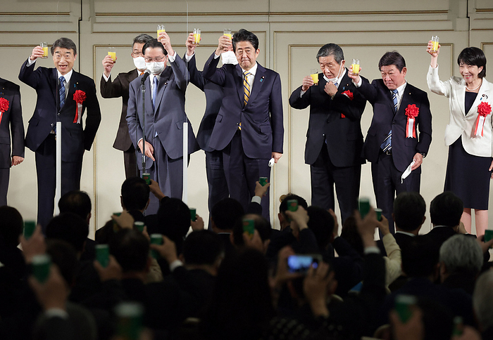 Former Prime Minister Shinzo Abe  center  and others raise glasses filled with juice at the first political fundraiser since the Abe faction was established. Former Prime Minister Shinzo Abe  center  and others raise glasses filled with juice at the first political fundraiser since the Abe faction was established, in Minato Ward, Tokyo, December 6, 2021, 6:48 p.m. Photo by Masahiro Ogawa