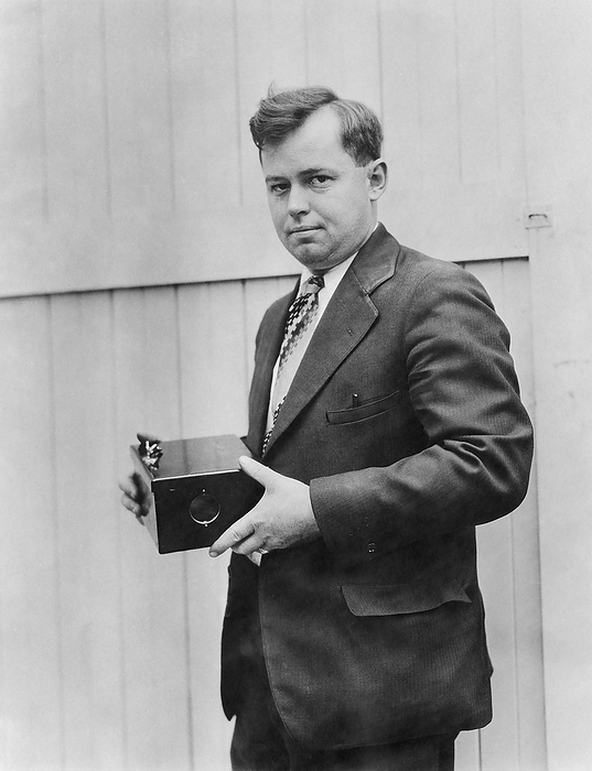 Robert Burt, US physicist and inventor Editorial use only   Robert C Burt  b. 1896 , US physicist and inventor, holding a photoelectric cell developed for use in burglar alarm systems. Photoelectric cells are used to convert light falling on them into electricity. In an alarm system, the absence of light falling on the cell and the resulting drop in electrical current triggers the alarm. 