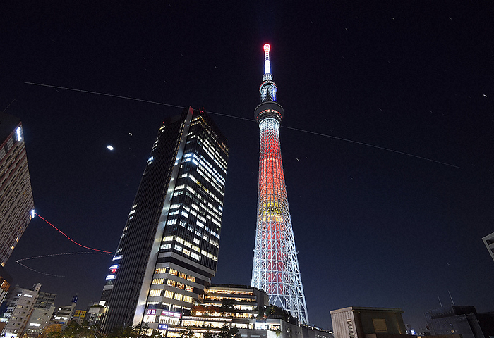 The light trail of the ISS  center, right to left  passing beyond the Tokyo Sky Tree with Yusaku Maezawa and others aboard. The lower left is the light trail of an aircraft. The light trail of the ISS  center, right to left  passing beyond the Tokyo Sky Tree with Yusaku Maezawa and others aboard. The lower left is the light trail of an aircraft. Photographed by Koichiro Tezuka on December 9, 2021 in Sumida ku, Tokyo  68 images taken with a 2 second exposure from 5:37 p.m. were compared and brightly composited .