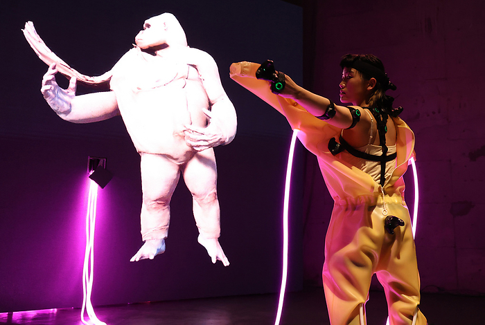 Shota Yamauchi s digital art using motion capture technology at an exhibition of Terrada Art Award December 10, 2021, Tokyo, Japan   A dancer strips off her rubber skin while a gorilla mimics her action on a large LED screen with motion capture technology for an installation  Maihime  or a dancing girl, produced by Japanese digital artist Shota Yamauchi at a press preview at Wearhouse Terrada s art space in Tokyo on Friday, December 10, 2021. Terrada announced five finalists of  Terrada Art Award 2021  and Yamauchi is one of the five finalists.      Photo by Yoshio Tsunoda AFLO 