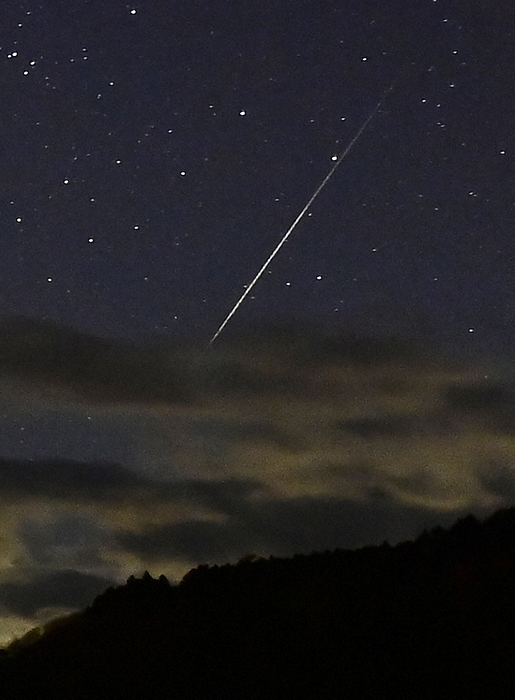 Shooting Stars of the Geminids Meteor Shower in the Clouds Shooting stars of the Geminids meteor shower flowing through the clouds at the shore of Lake Seishin in Fujikawaguchiko Town, Yamanashi Prefecture, December 1, 2021. December 1, 2021 at 5:15 a.m.