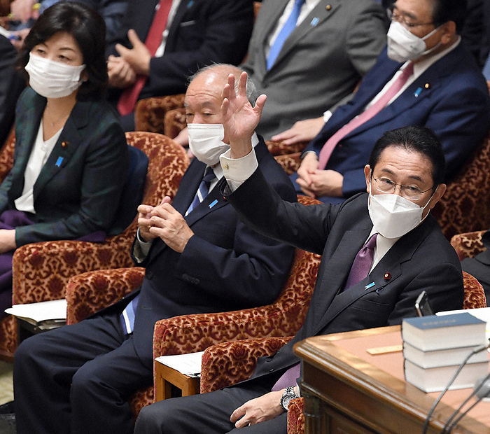 Diet, Budget Committee of the House of Representatives Prime Minister Fumio Kishida  right  raises his hand to answer a question from Mr. Toru Miyamoto of the Communist Party at the Budget Committee of the House of Representatives, 11:31 a.m., December 15, 2021 in the Diet.