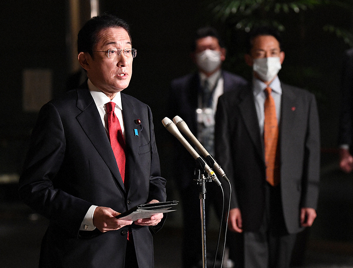 Prime Minister Fumio Kishida  left  answers reporters  questions about the confirmation of a citywide infection of an Omicron strain in Osaka. Prime Minister Fumio Kishida  left  answers reporters  questions about the confirmation of a citywide infection of the Omicron strain in Osaka, Japan, at the Prime Minister s official residence in 2021. Photo by Miki Takeuchi, 5:58 p.m., December 22, 2010