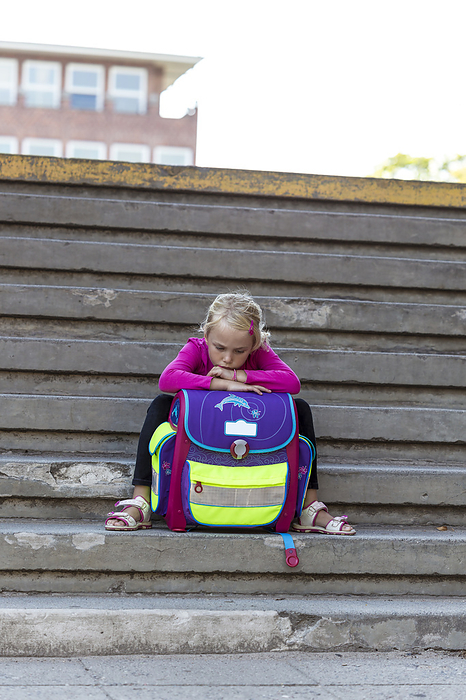 Blond girl sitting with school bag on stairs, Kiel, Schleswig-Holstein, Germany, Europe, Photo by Fernow/F1online