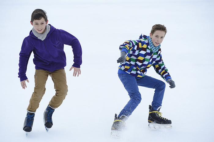 Two boys ice-skating on a frozen lake, Photo by David & Micha Sheldon/F1online