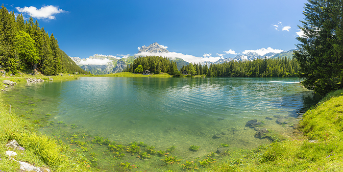 Switzerland Panoramic of the clear water of Lake Arnisee surrounded by green woods, Canton Uri, Switzerland, Photo by Roberto Moiola