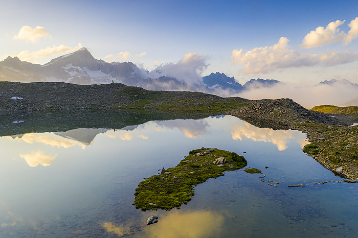 Switzerland Galenstock mountain mirrored in the clear water of Obere Schwarziseeli lake at sunrise, Furka Pass, Canton Uri, Switzerland, Photo by Roberto Moiola