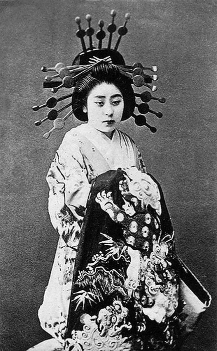 Japan: A late 19th century oiran or courtesan   prostitute Japan: A late 19th century oiran or courtesan   prostitute  The oiran were considered a type of y jo  prostitute   woman of pleasure  or prostitute. However, they were distinguished from the y jo in that they were entertainers, and many became celebrities of their times outside the pleasure districts. Their art and fashions often set trends among the wealthy and, because of this, cultural aspects of oiran traditions continue to be preserved to this day. br   br  They were distinguished from the y jo  woman of pleasure  or prostitute.  The oiran arose in the Edo period  1600 1868 . At this time, laws were passed restricting brothels to walled districts set some distance from the city center. In the major cities these were the Shimabara in Kyoto, the Shinmachi in Osaka, and the Yoshiwara in Edo  present day Tokyo .  br   br   br  These are the major cities.  These rapidly grew into large, self contained  pleasure quarters  offering all manner of entertainments. Within, a courtesan s birth held no distinction, which was fortunate considering many of the courtesans originated as the daughters of impoverished families who were sold into this lifestyle as indentured servants.   Among the oiran, the tay   tayu  was considered the highest rank of courtesan and were considered suitable for the daimyo or feudal lords. In the mid 1700s courtesan rankings began to disappear and courtesans of all classes were collectively known simply as  oiran .  br   br    The word oiran comes from the Japanese phrase oira no tokoro no n san            which translates as  my elder sister . When written in Japanese, it consists of two kanji, flower meaning  flower , and kai meaning  leader  or  first , hence  Leading Flower  or  First Flower .