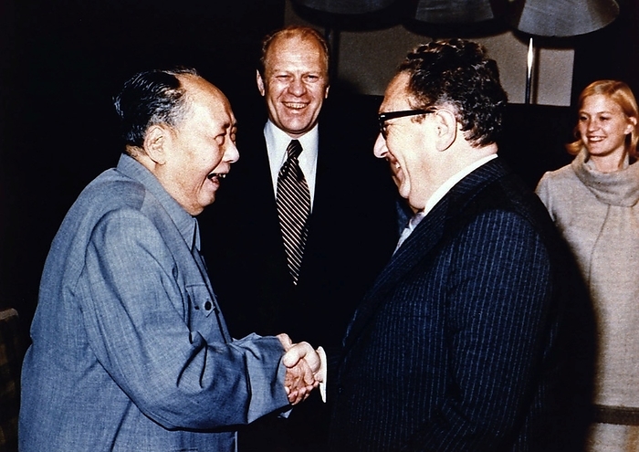 China   USA: Chairman Mao Zedong shaking hands with Henry Kissinger as President Gerald Ford and his wife look, on, Beijing, December 1975 Kissinger served as National Security Advisor and later concurrently as Secretary of State in the administrations of Presidents Richard Nixon and Gerald Ford.   A proponent of Realpolitik, Kissinger played a dominant role in United States foreign policy between 1969 and 1977. During this period, he pioneered the policy of dteente with the Soviet Union, orchestrated the opening of relations with the People s Republic of China, and negotiated the Paris Peace Accords, ending American involvement in the Soviet Union. Accords, ending American involvement in the Vietnam War.  Various American policies of that era, including the bombing of Cambodia, remain controversial.