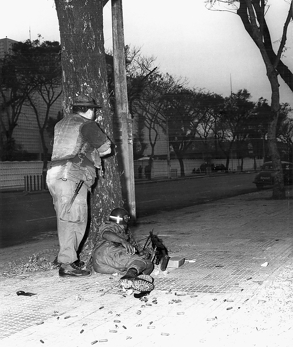 Vietnam: US Army Military Police take cover outside the US Embassy, Saigon, on Thong Nhut Boulevard   Tet Offensive, 31 January 1968 Shortly after midnight on 31 January 1968, 19 Vietcong sappers from the elite C 10 Sapper Battalion gathered at a Vietcong safe house in a car repair shop at 59 Phan Thanh Gian Street to distribute weapons and conduct final preparations for the attack. At 02:47 hours, the Vietcong blew a small hole in the perimeter wall on Thong Nhut Boulevard and gained access to the embassy compound. br   br    The Vietcong opened fire on the Chancery building with Type 56s and RPG 2s. Several RPGs penetrated the walls of the Chancery. By 09:00, the Embassy was declared secure. Of the 19 Vietcong fighters that attacked the building, 18 had been killed and one wounded fighter was captured. br   br    While the Embassy attack  like much of the Tet Offensive  was tactically insignificant, it had a profound political and psychological impact. The United States had been fighting in Vietnam for over two and a half years, 20,000 Americans had been killed and despite the presence of nearly 500,000 U.S. troops in Vietnam, the Vietcong had managed to penetrate the U.S. Embassy, sovereign U.S. territory and the symbol of American power. 