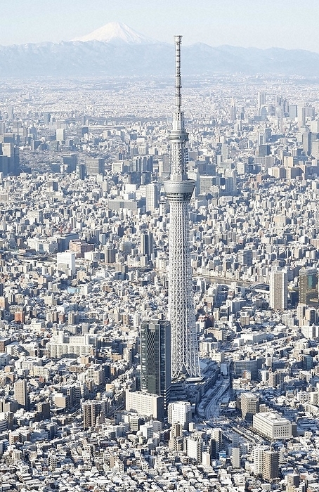 Tokyo covered with snow. Tokyo Sky Tree in the foreground and Mt. Tokyo covered with snow. Tokyo Sky Tree in the foreground and Mt. from the head office helicopter at 8:05 a.m. on January 7, 2022.