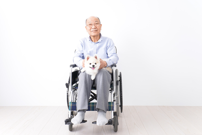 Elderly man in wheelchair with dog