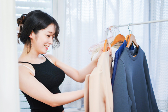 Young woman preparing clothes
