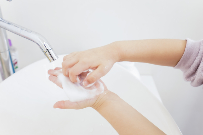 A girl washing her hands