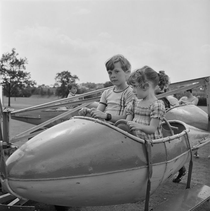 Laing Sports Ground, Rowley Lane, Elstree, Barnet, London, 30 06 1984. Creator: John Laing plc. Laing Sports Ground, Rowley Lane, Elstree, Barnet, London, 30 06 1984. Two children in a model aeroplane on fairground ride at a Gala Day held at the Laing Sports Ground at Elstree. Laing s annual summer gala day was held on 30th June 1984 at the Laing Sports Club at Rowley Lane. The day included sporting competitions for adults and children, 31 stalls, charity events, and an evening barbecue. Over 2,000 people attended the gala day.