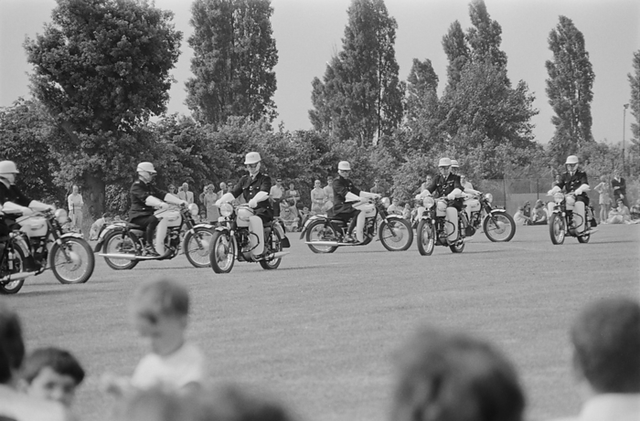 Laing Sports Ground, Rowley Lane, Elstree, Barnet, London, 14 06 1969. Creator: John Laing plc. Laing Sports Ground, Rowley Lane, Elstree, Barnet, London, 14 06 1969. The Metropolitan Police Motorcycle Precision Team giving a display of formation riding during a Gala Day held at the Laing Sports Ground at Elstree. A Gala Day was held by Laing at the Laing Sports Ground on 14th June 1969, as a replacement of the annual Sports Day. Sports events were held by the Sports Club, which included hockey, tennis, bowls, and football tournaments. A traditional English fete programme featured coconut shies, bingo, pony rides, catering and a beer tent, candy floss, and roundabouts. The day ended with a beauty contest, prize draw, and the election of Miss Sports Club. In the evening there was a firework display and a gala dance which continued until midnight.