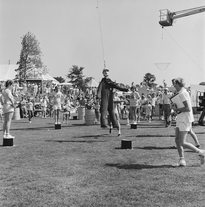 Laing Sports Ground, Rowley Lane, Elstree, Barnet, London, 21 06 1986. Creator: John Laing plc. Laing Sports Ground, Rowley Lane, Elstree, Barnet, London, 21 06 1986. People competing in the  swinging dummy  stage of the  It s a Knockout  style competition at the 1986 Family Day at Laing s Sports Ground. Over 2500 people attended the Family Day and raised over   xa3 700 for that year s designated charity The British Heart Foundation.  Attractions included  guest appearances by the cast of the television programme Grange Hill, a bouncy castle, donkey rides, Punch and Judy shows, Pierre the Clown, children s races, blindfold stunt driving and golf and six a side football tournaments.  Eight teams entered the  It s a knockout  competition and it was won by a team named  The Floppies  from the Information Services Department.