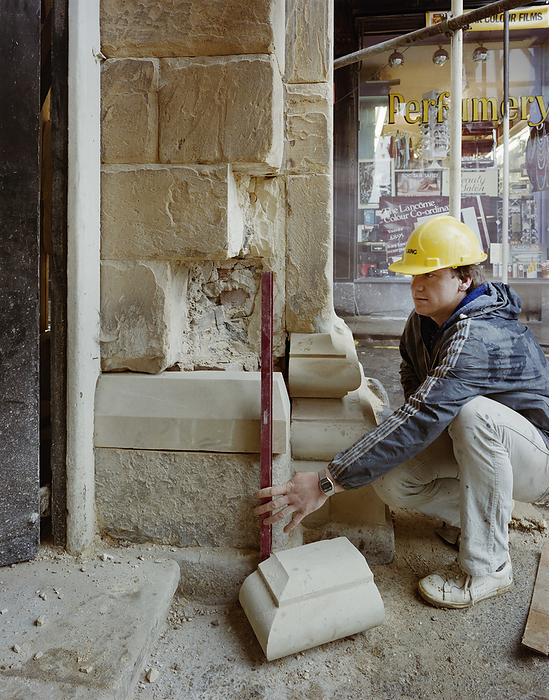 Buttercross, High Street, Ludlow, Shropshire, 21 05 1985. Creator: John Laing plc. Buttercross, High Street, Ludlow, Shropshire, 21 05 1985. A stonemason holding a spirit level prior to replacing a block of stone during renovation work at the Buttercross. Renovation work on the Buttercross was carried out by Laing Stonemasonry with work starting in August 1984. The grade I listed building, which was originally built in 1743 46, was restored using the local Grinshill Sandstone from Shropshire. The architects for the refurbishment were Catterall, Morris  amp  Jaboor of Shrewsbury.