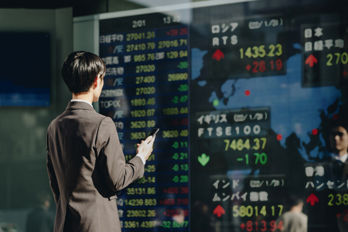 Japanese man watching the world market (Stock Price Board) (People)
