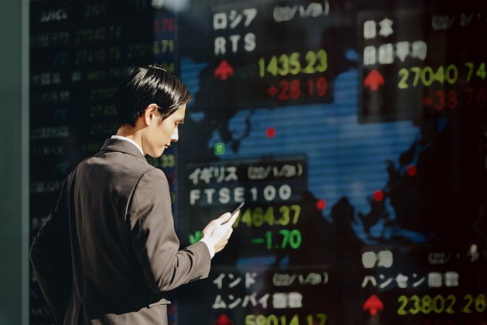 Japanese man watching the world market (Stock Price Board) (People)