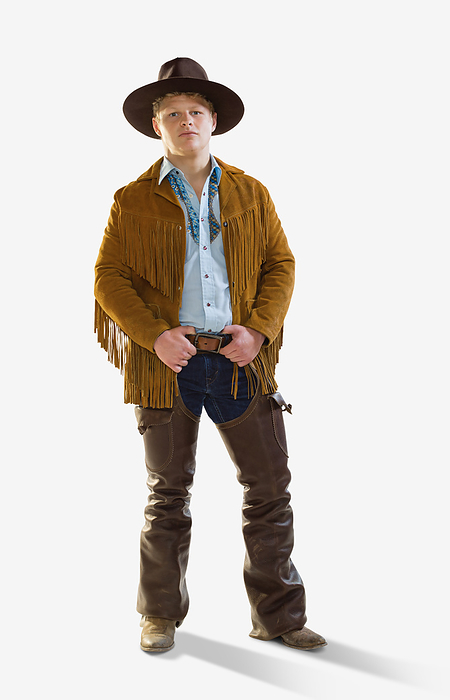 Male Cowboy with hands on belt looking at camera with serious expression, against a white background