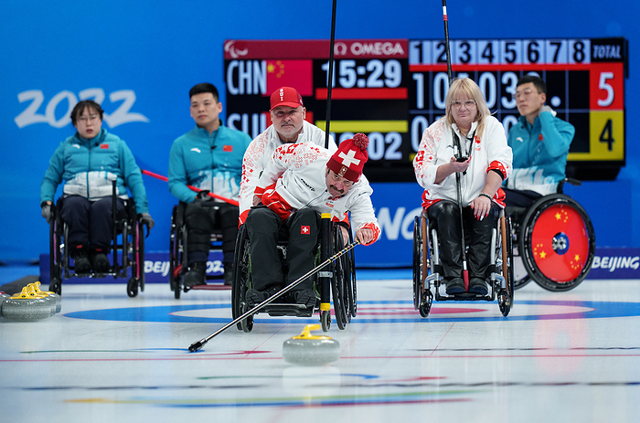 2022 Beijing Paralympics Wheelchair Curling Qualifier  courtesy photo  Hans Burgener SUI plays a stone in the Wheelchair Curling Round Robin Session 8   People s Republic of China vs Switzerland at the National Aquatics Centre. Beijing 2022 Winter Paralympic Games, Beijing, China, Monday 07 March 2022. Photo: OIS Joe Toth. Handout image supplied by OIS IOC COPYRIGHT OF OLYMPIC INFORMATION SERVICES. COMMERCIAL USE IS PROHIBITED.