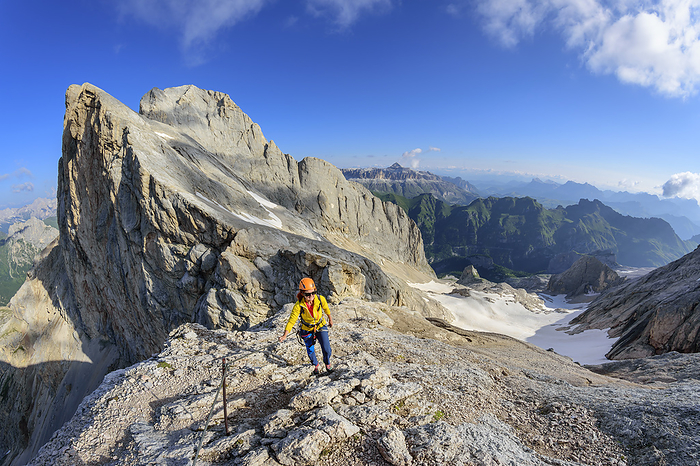 Female climber ascending ridge of Marmolada mountain, Photo by Andreas Strauß