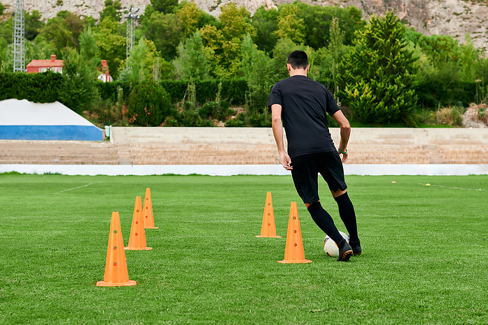 A football player training on a soccer field, Villena, Valencian Community, Spain