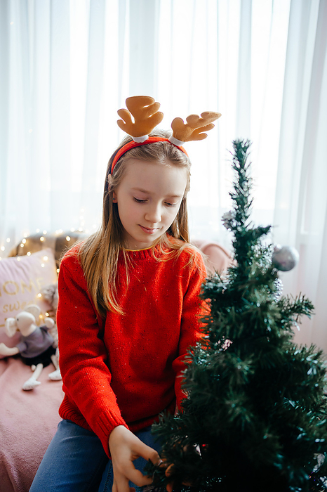 girl in a christmas costume decorates the christmas tree, Poltava, Poltava Oblast, Ukraine