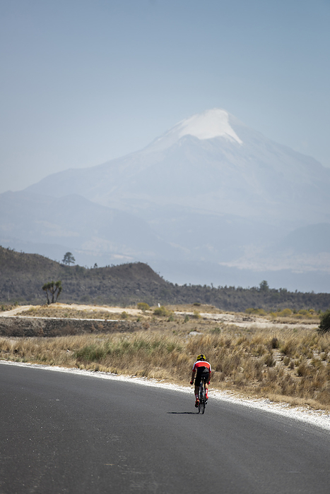 One person road cycling by himself on his way to Pico de Orizaba, Tlachichuca, Pue., Mexico