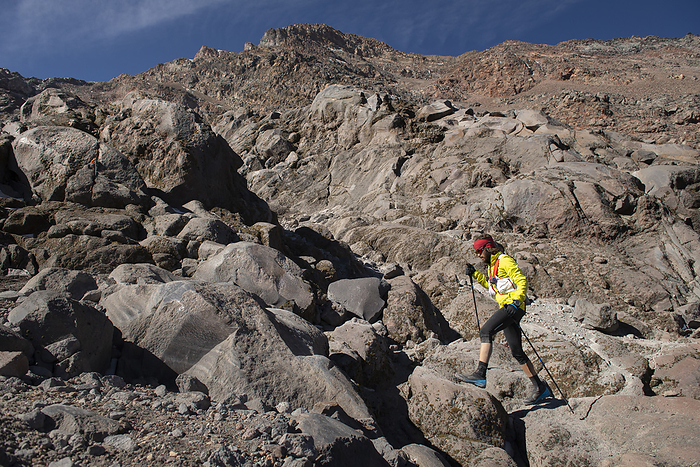 One man using poles hikes through a moraine climbing Pico de Orizaba, Citlaltépec, Ver.
