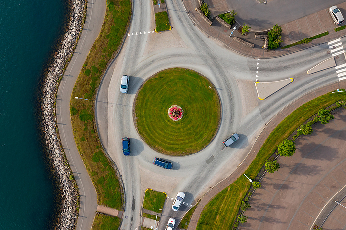 Top view of vehicles driving on asphalt roundabout, Hafnarfjordur, Iceland