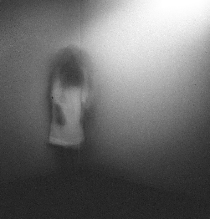 Ghost girl in white nightgown standing in corner of room at home, Grimes, Iowa, United States