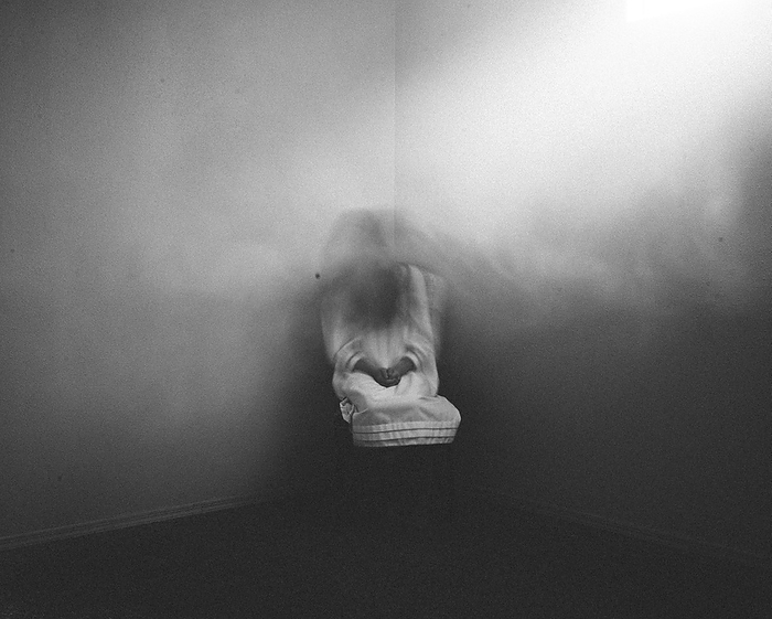 Scary ghost girl sitting in foggy haunted corner of house, Grimes, Iowa, United States